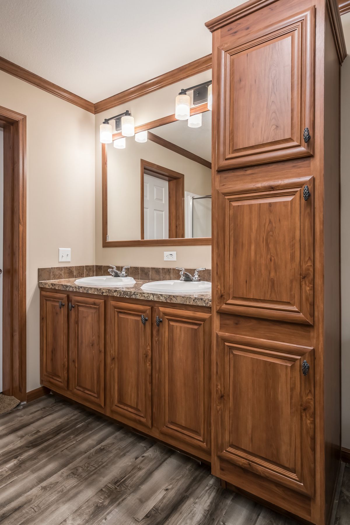 A bathroom with wooden cabinets and counter tops.