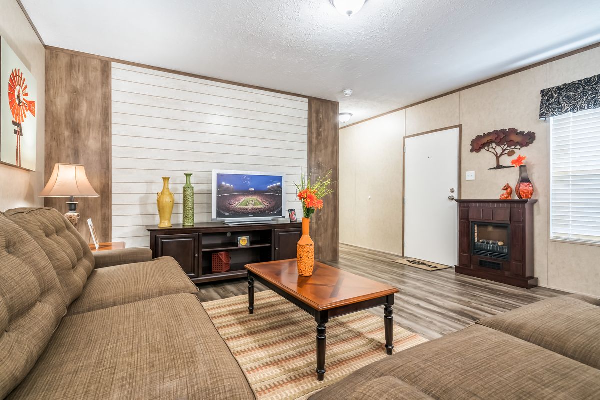 A living room with couches and a tv.