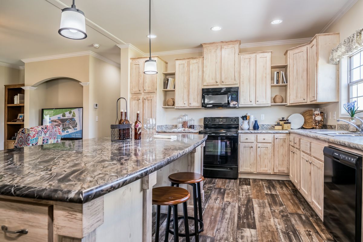 A kitchen with wood cabinets and granite counter tops.