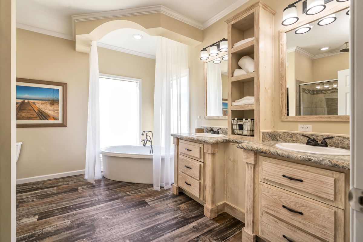A bathroom with two sinks and a tub.
