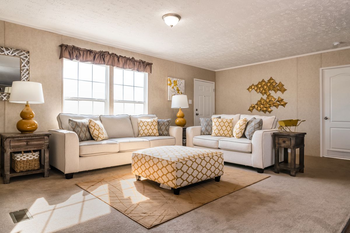 Beige furniture and yellow accents add vibrancy to this living room.