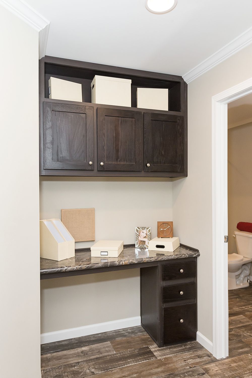 null A home office with a desk and cabinets.