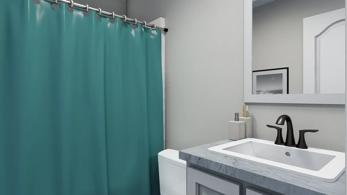 A bathroom with a teal shower curtain.