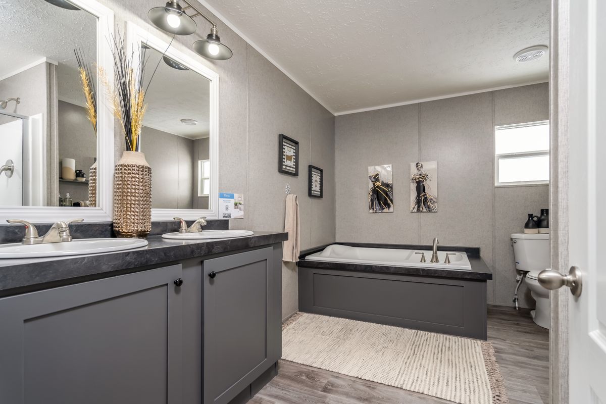 a39bd036-7fe4-453d-b98a-20a249a7b041 Gray bathroom, tub, sink.