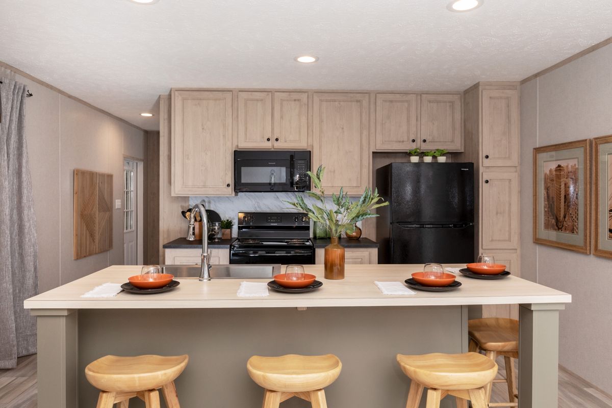 a5be1d2b-cb23-48ff-8b56-5b37054d99d1 A kitchen with bar stools and a refrigerator.
