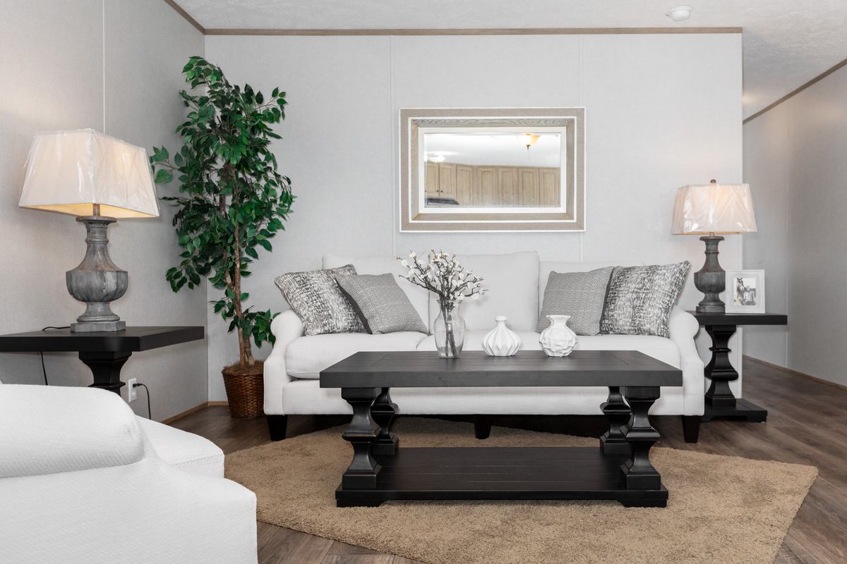 a75e8432-7aeb-4dc3-95bc-0800bc53834b A living room with white furniture and a coffee table.