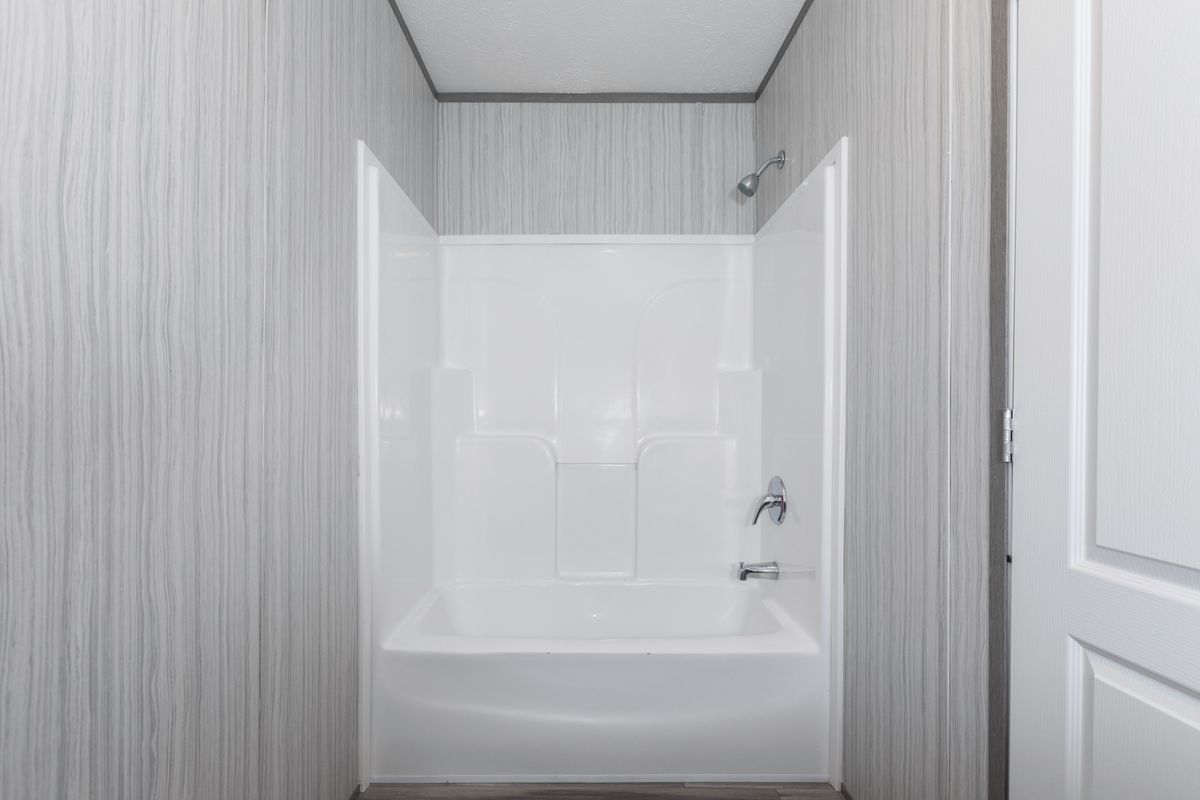 a874a470-1a4c-43fb-a975-62d82cb9606f A white bathroom with a toilet and shower.