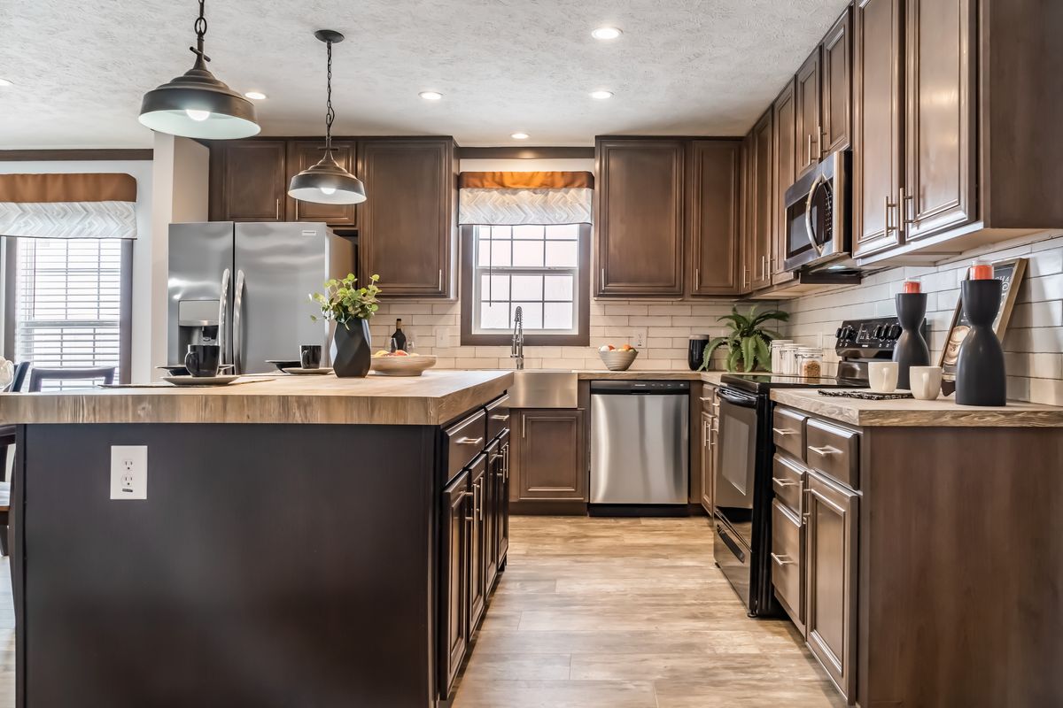 A kitchen with wood cabinets and stainless steel appliances.