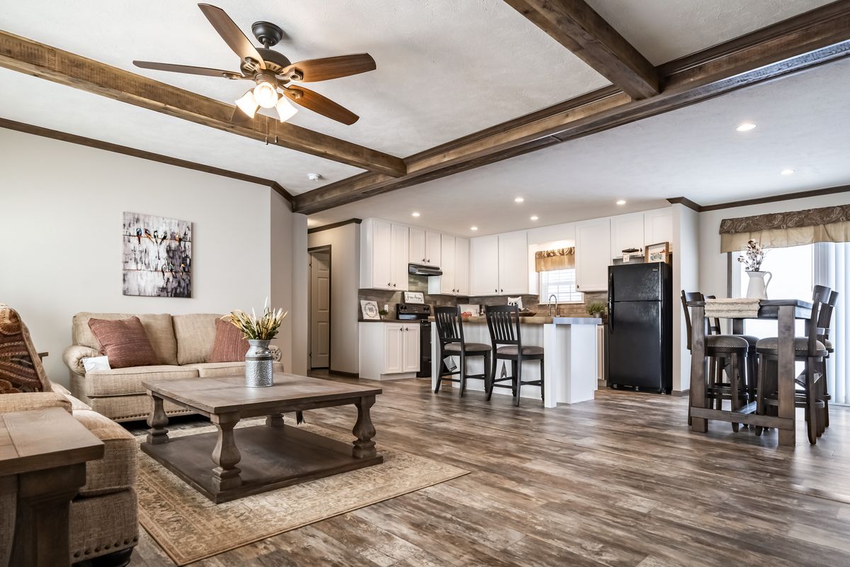 A living room with hardwood floors and a ceiling fan.