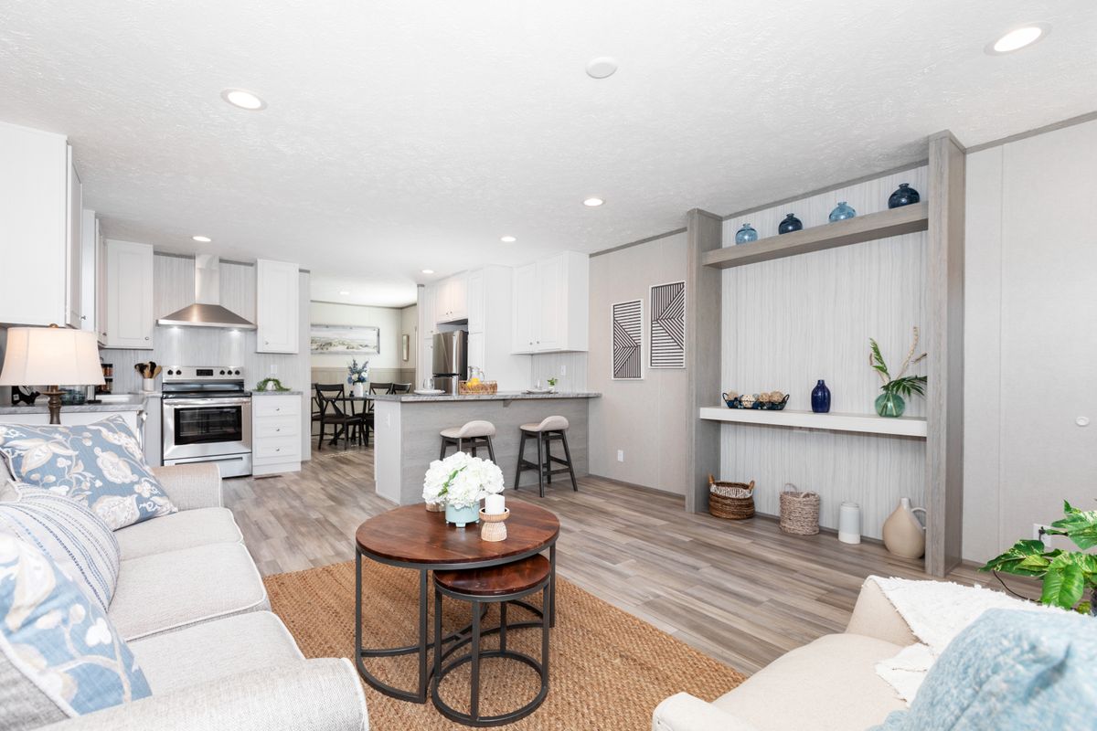 ae6f77e8-53d2-48f6-91c6-069cb5ba02b1 A living room and kitchen in a modern home.