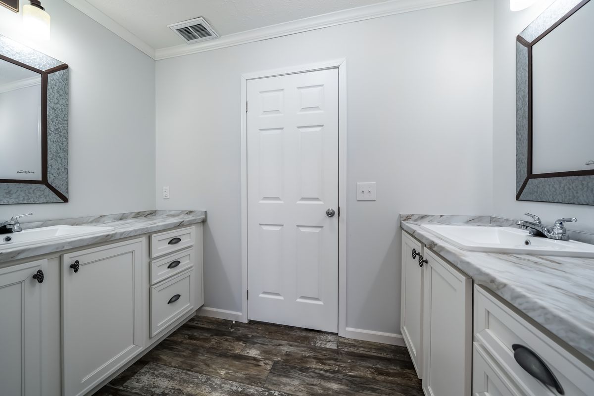 30CEE16682AH
Clayton Waycross Facility 930 A bathroom with two sinks and a mirror.