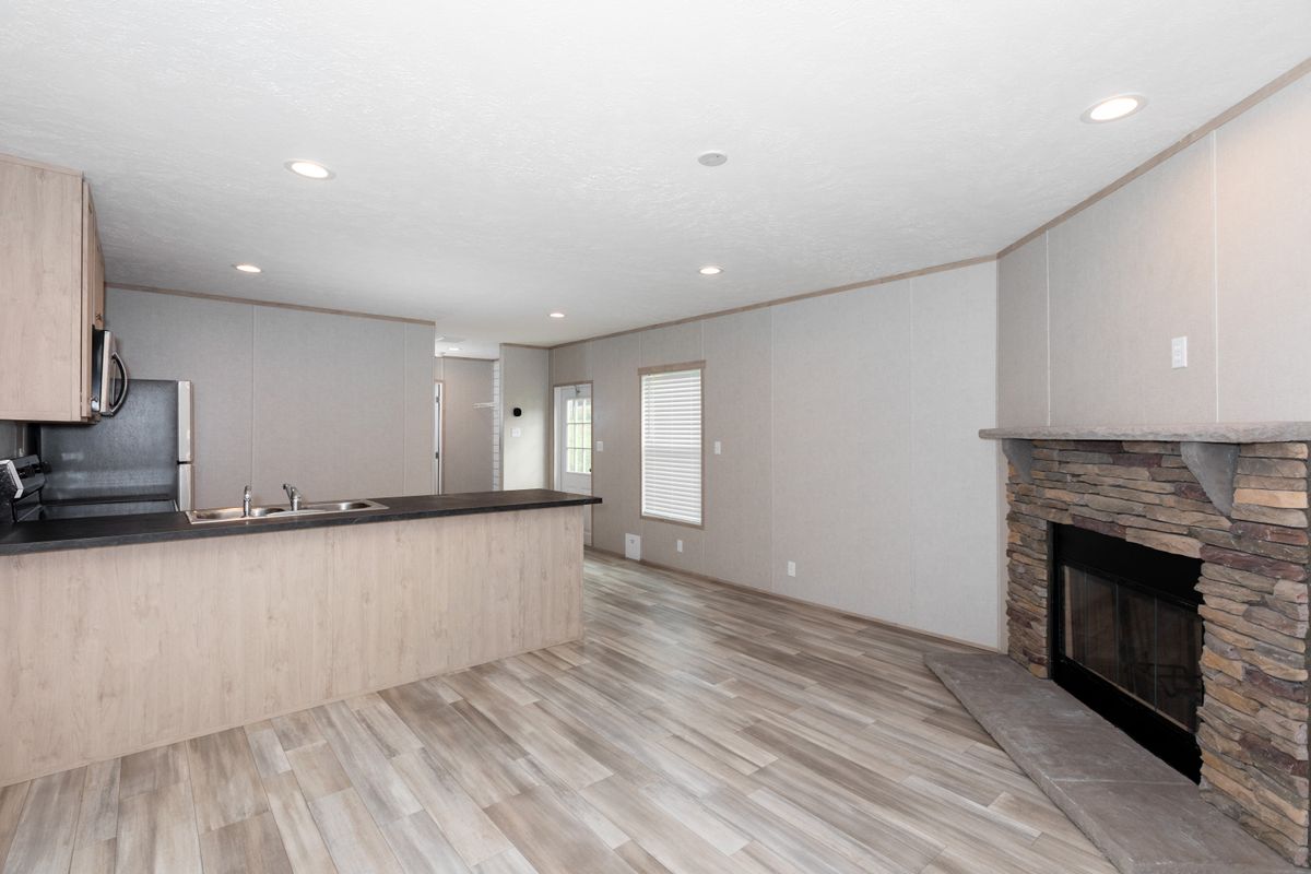 b0594397-8f70-4ac4-87ce-e892b21f65f7 A kitchen with wood floors and a fireplace.
