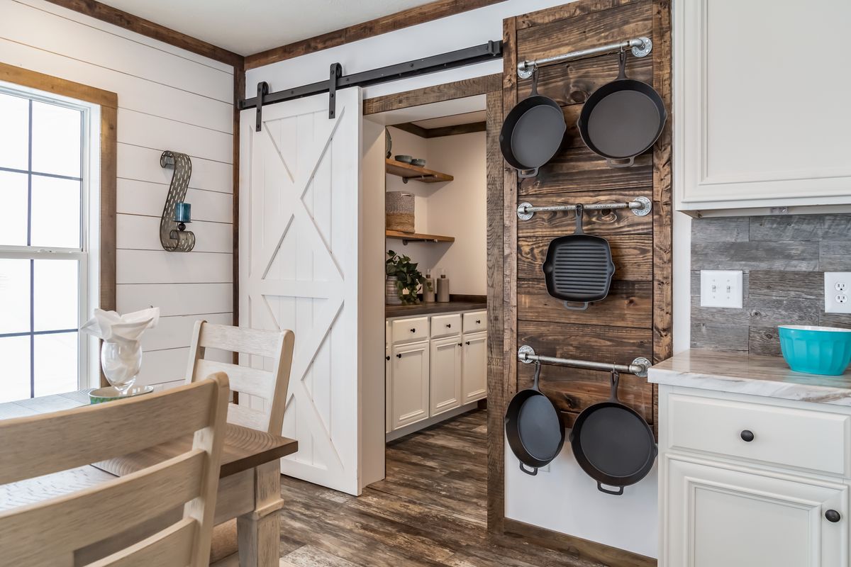 c05149a1-720d-4a13-8843-0a7afe7b7c2d A kitchen with a rustic sliding barn door.