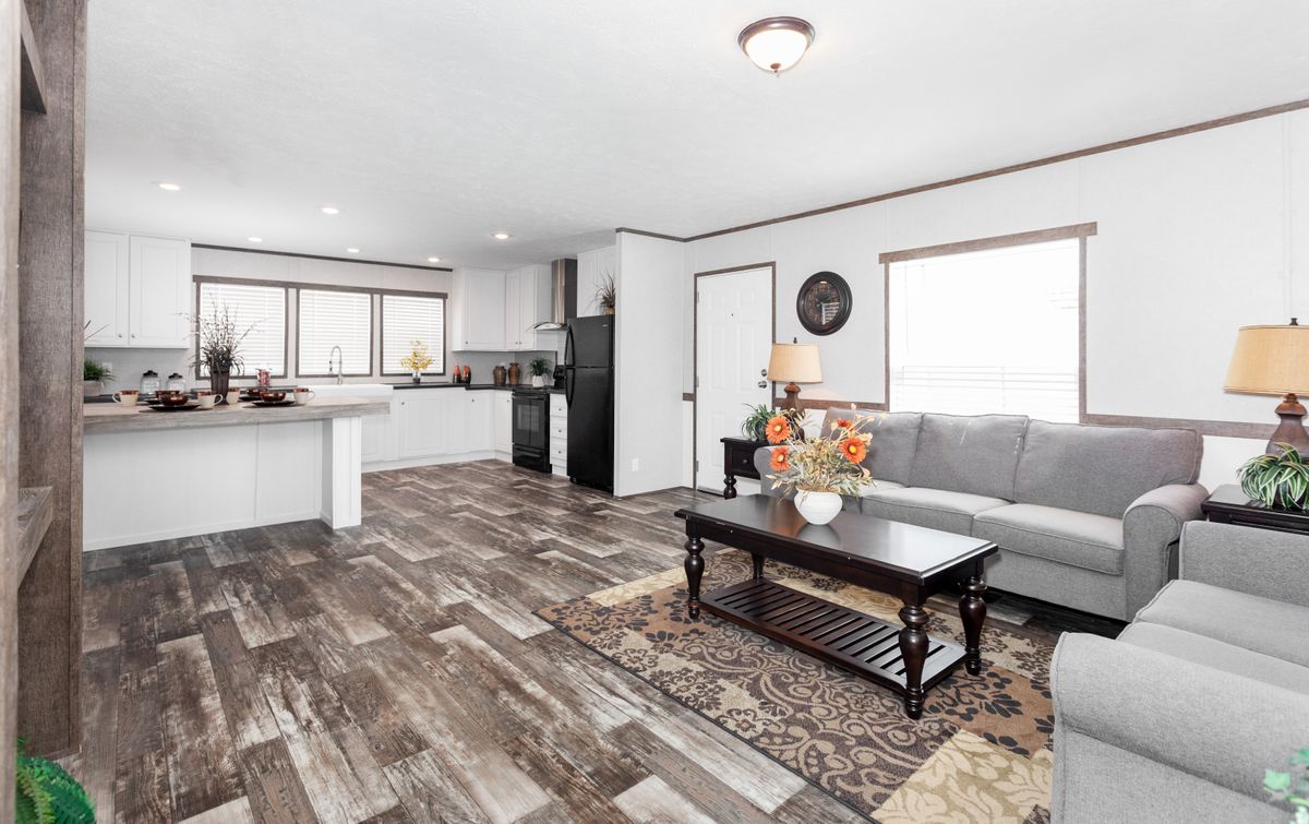 A living room and kitchen in a mobile home.