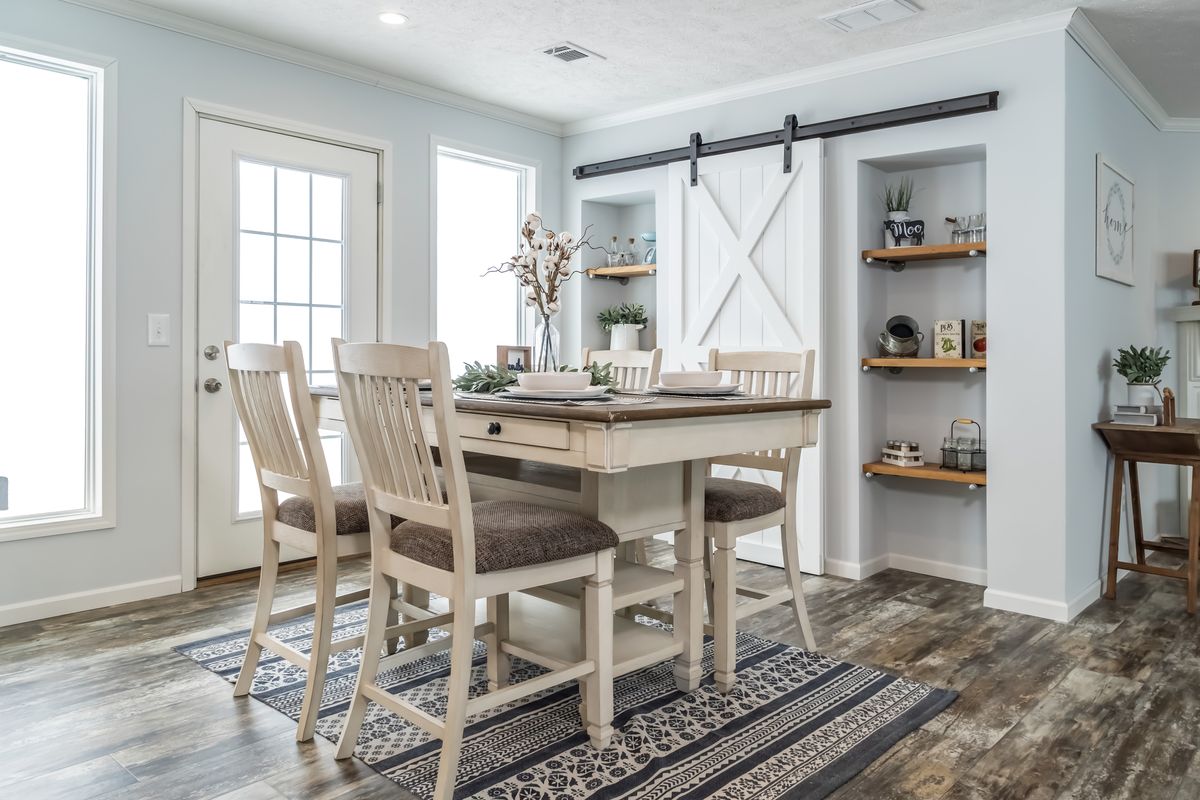 30CEE16682AH
Clayton Waycross Facility 930 A dining room with a wooden table and chairs.