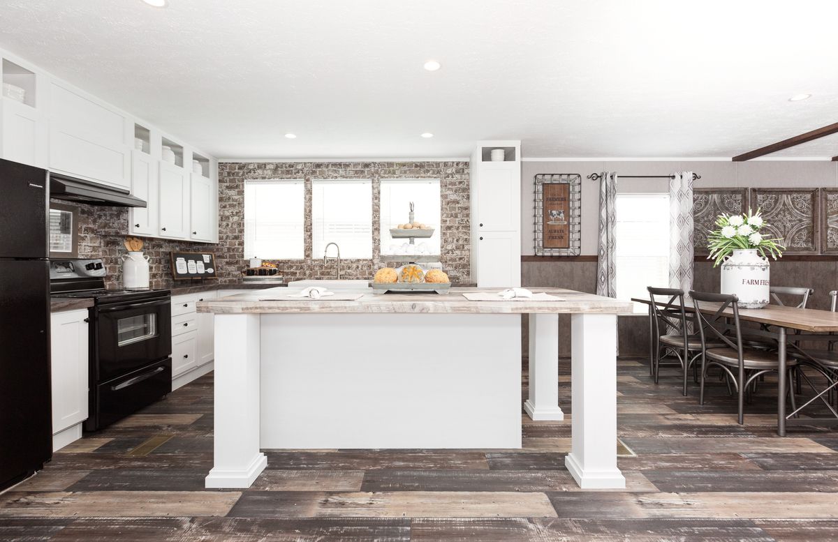 c44b738d-9251-44a1-8f16-c4a3b6c84a2a A kitchen with white appliances and wood floors.