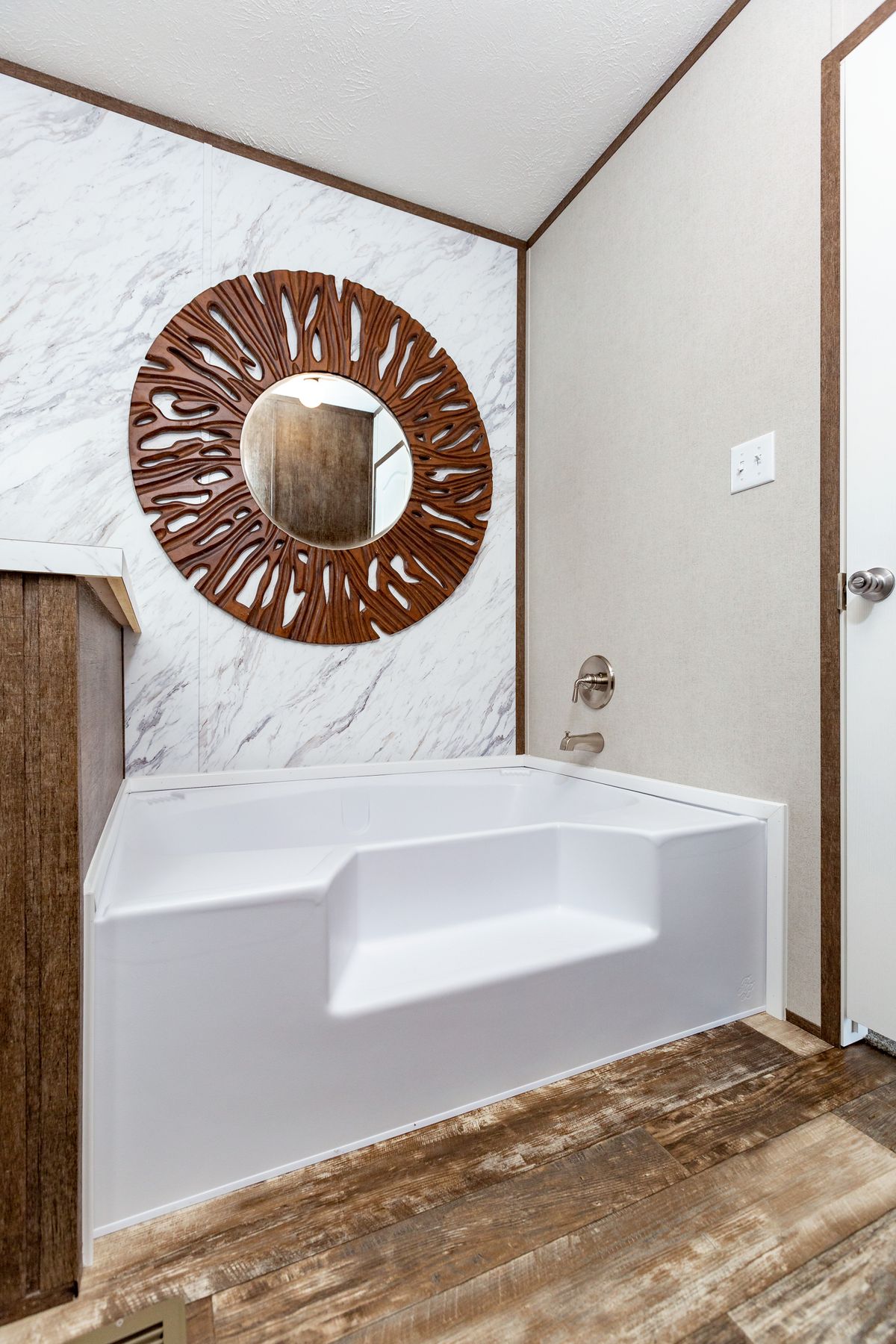c6e37fb5-4e1c-46e4-aeaf-2468599946f6 A bathroom with a bathtub and a mirror.