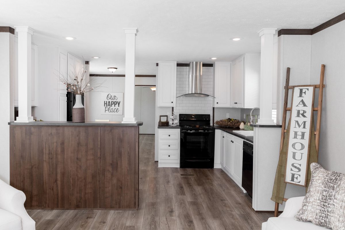 A living room and kitchen in a mobile home.