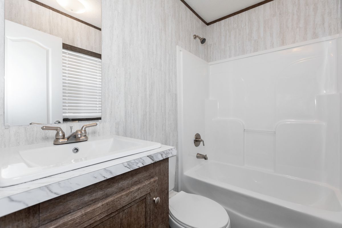 c8da5183-579d-4971-9db4-0db6f02f46eb A bathroom with a toilet and sink.
