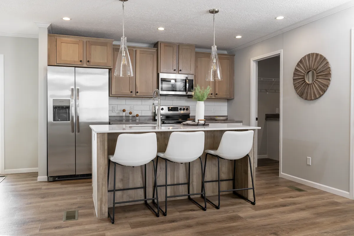 A kitchen with wood cabinets and stainless steel appliances.