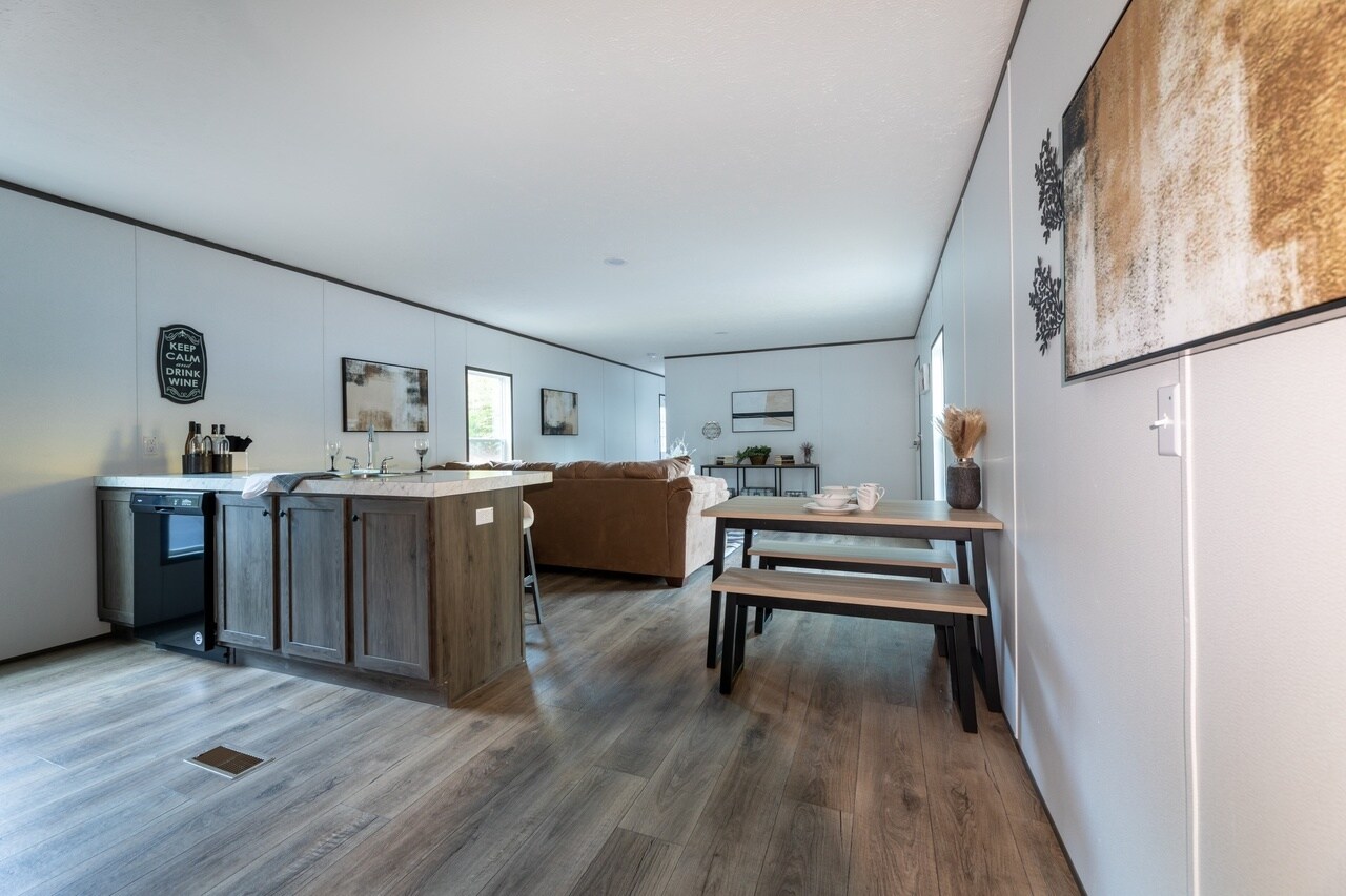 A living room and kitchen area in a mobile home.
