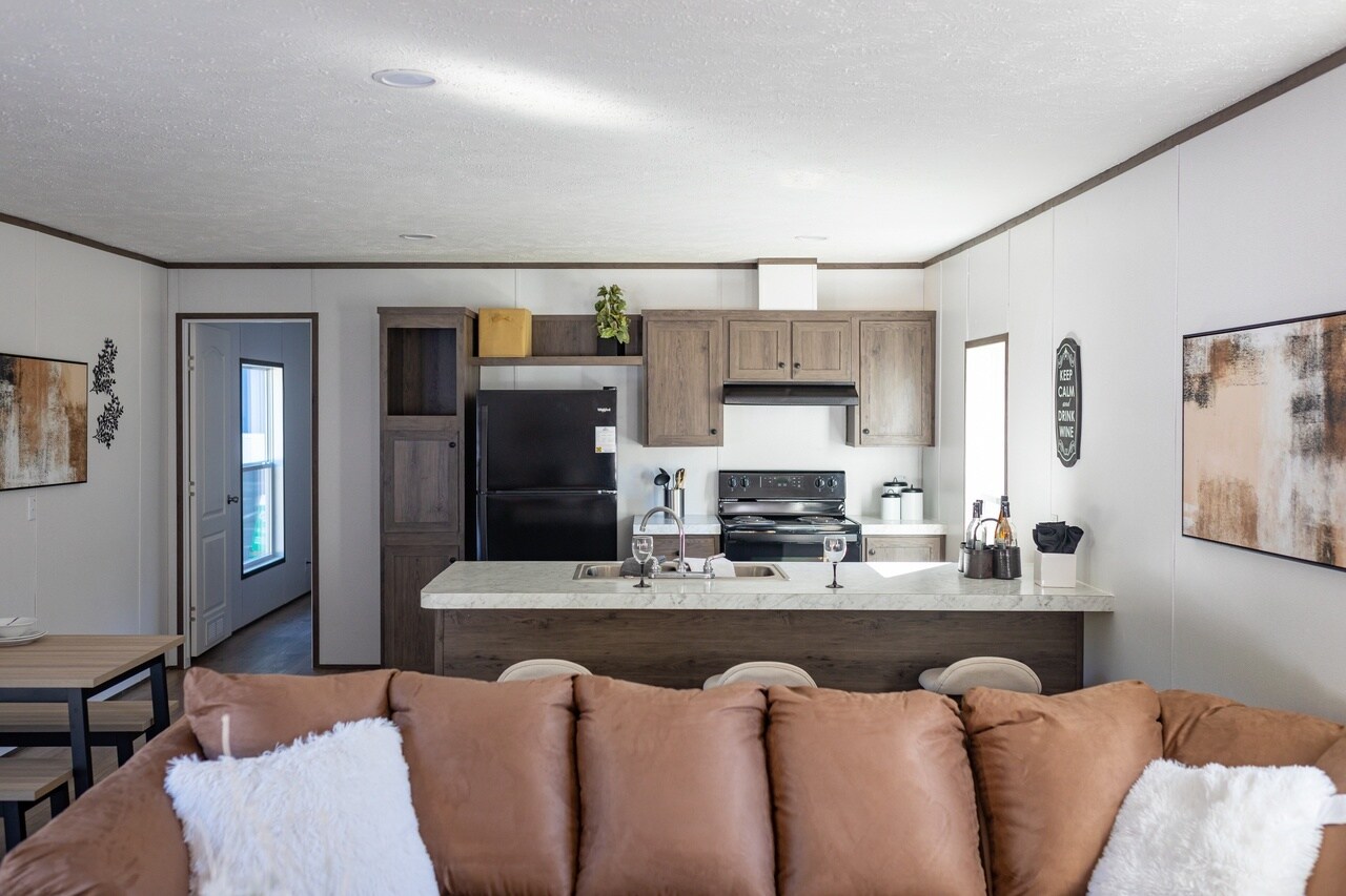 A living room and kitchen in a mobile home.