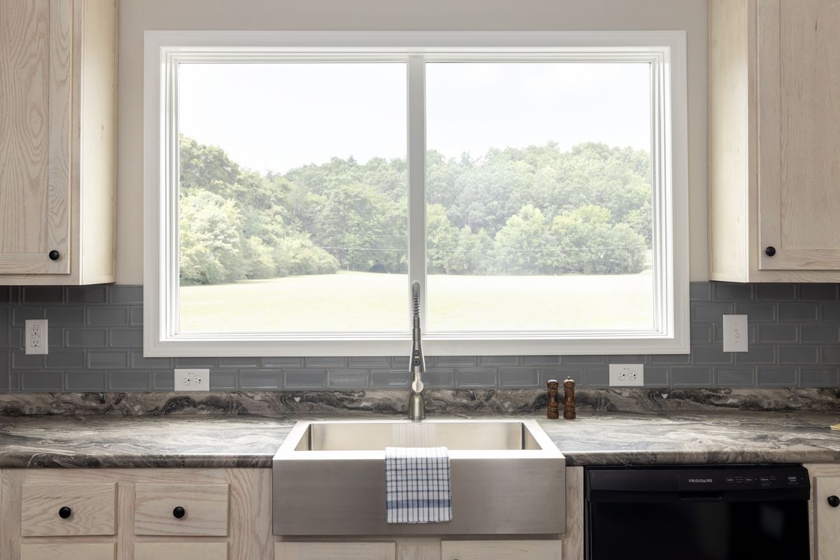 cc6fe970-9992-47c0-87e7-7a0d8acd9ac9 A kitchen with a sink and a window.