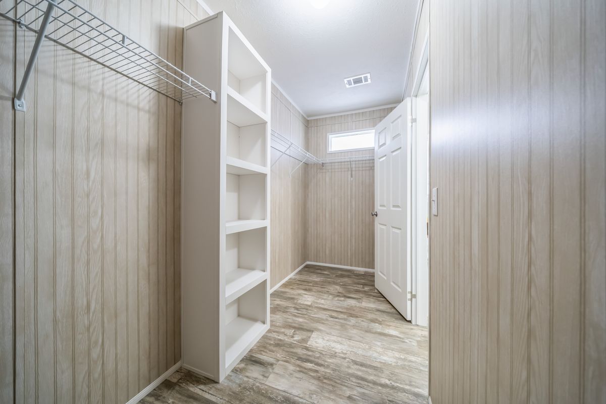 cf795b5a-39a3-4eeb-83eb-5d90a926aecd A walk in closet in a mobile home.
