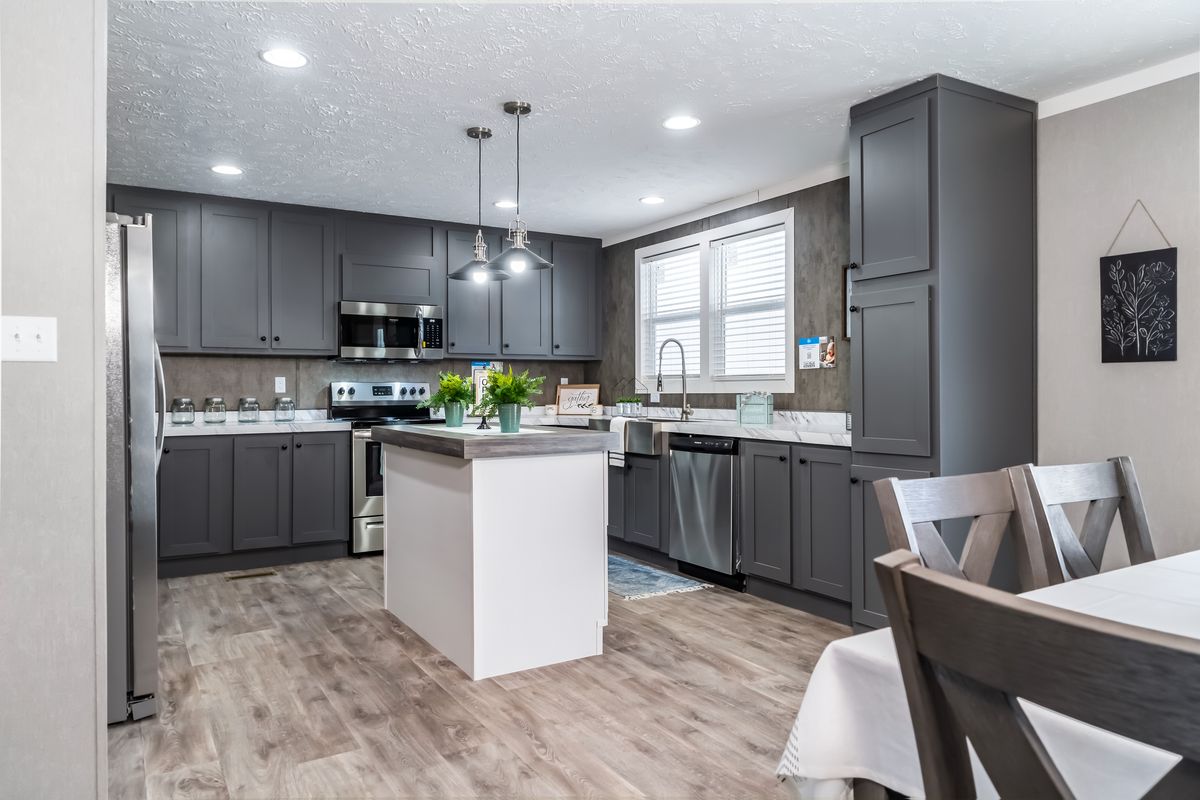 d0eb362c-62a6-44a4-881f-0620800b535f A kitchen with gray cabinets and hardwood floors.