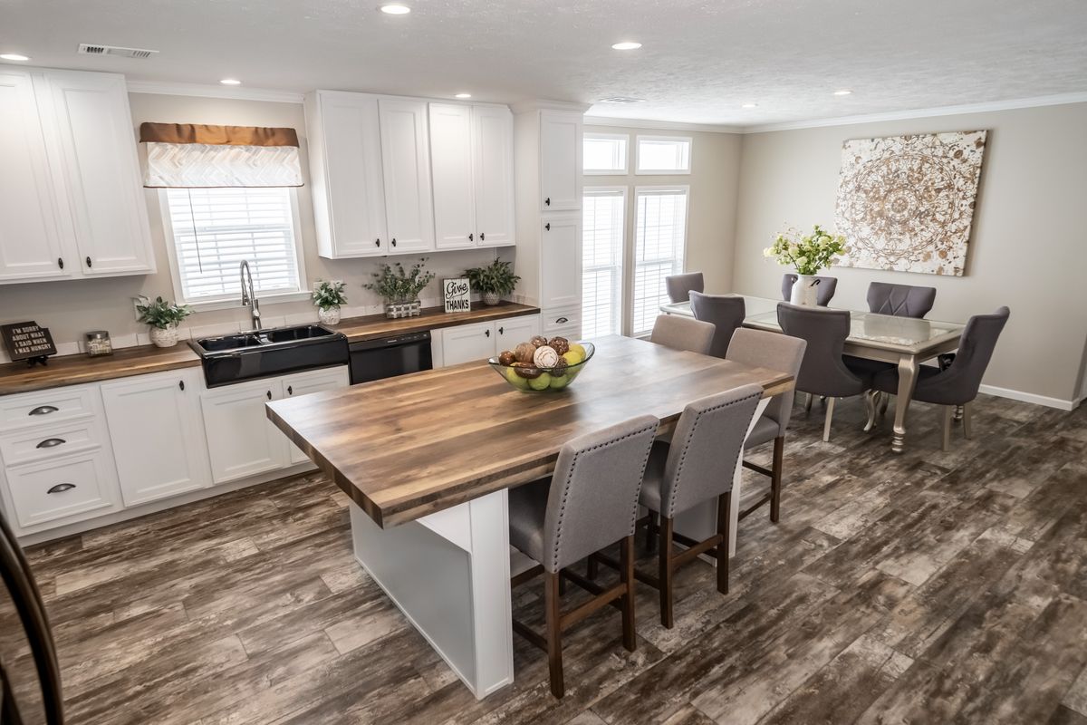 d2f2d863-ce7b-47c0-94d2-6d0dd1dce8b3 A kitchen in a mobile home with hardwood floors.