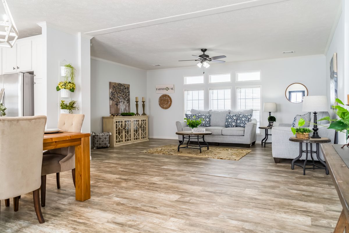 d588548e-87ec-4dd1-98bd-44961630d549 A living room with hardwood floors and a dining table.