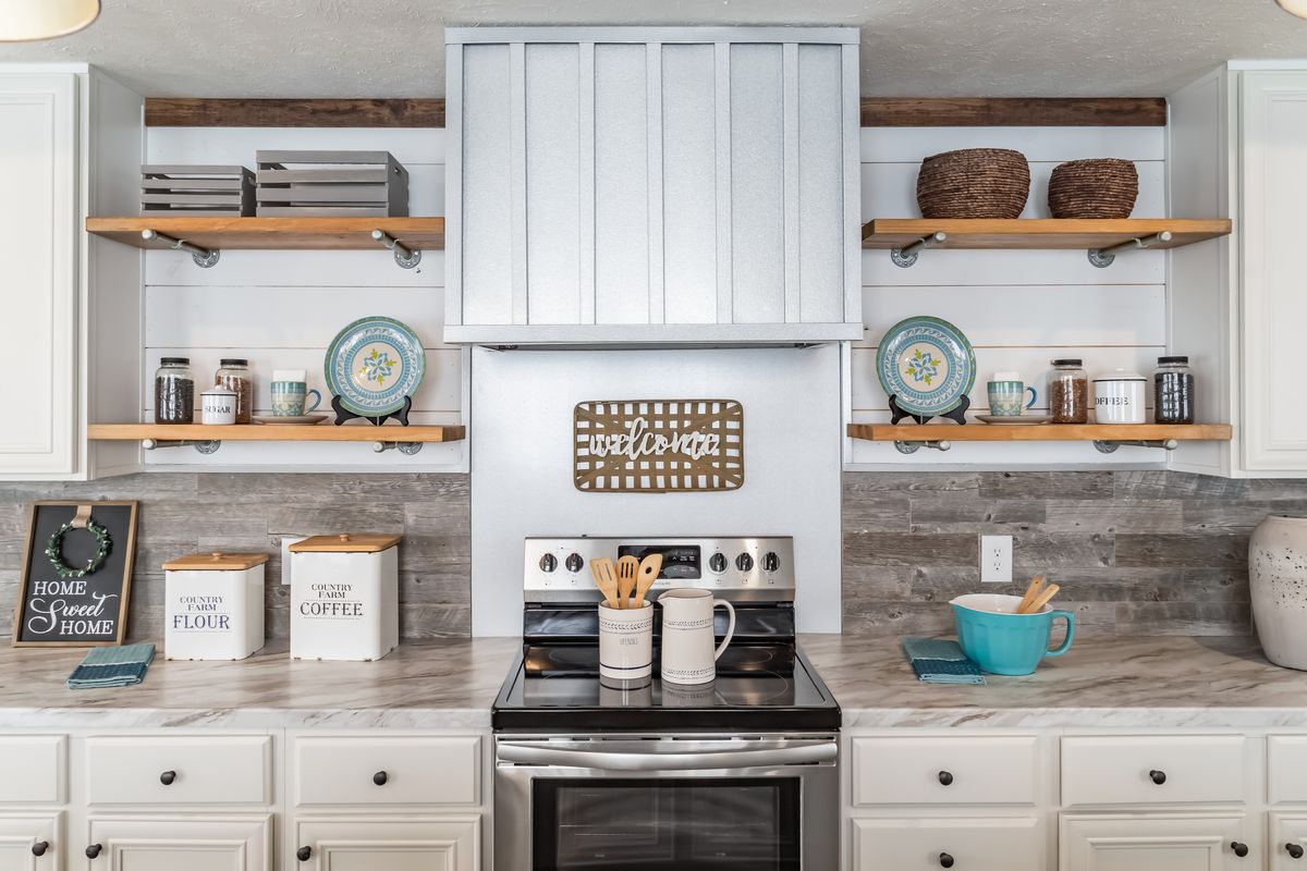 d597eb6a-1517-46fa-bf4b-11c66876413e A kitchen with white cabinets and a stove top features modern, clean aesthetics that are accentuated by the pristine white cabinetry. The sleek stove top adds sophistication to the overall design, making it a stylish