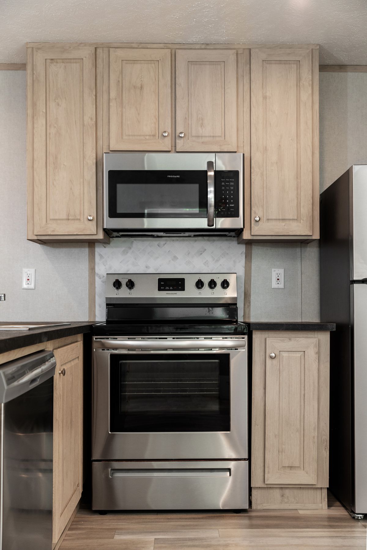 d607b146-0a46-498d-8b8d-49ba9a9310d5 A kitchen with stainless steel appliances and wood cabinets.