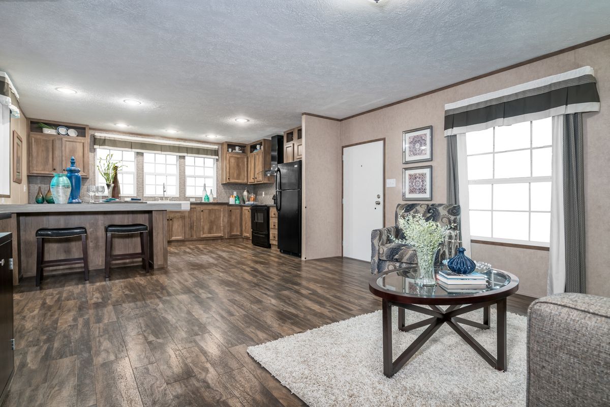 A living room and kitchen in a mobile home.