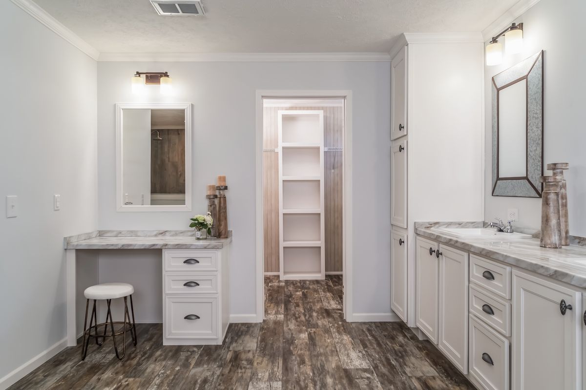 30CEE16682AH
Clayton Waycross Facility 930 A white bathroom with wood floors and a vanity.