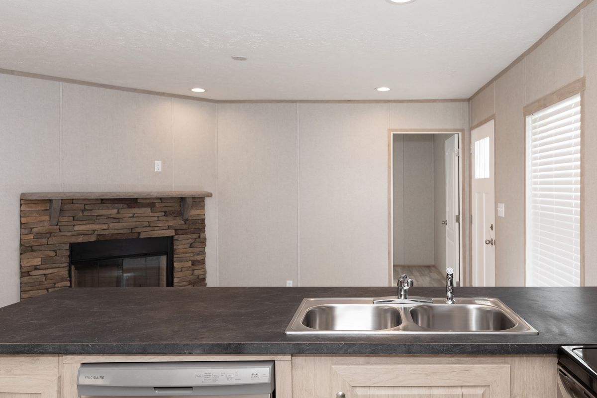 dbef29f3-c2f9-4e61-a46b-ffac69d4896f A small kitchen with a stove and sink.