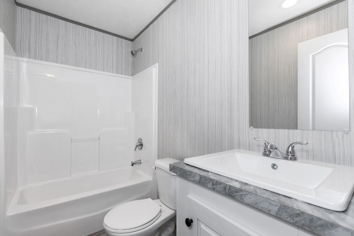 dc65d5d3-46ff-4fbf-9b93-eafaaded55c7 A white bathroom with a toilet and sink.