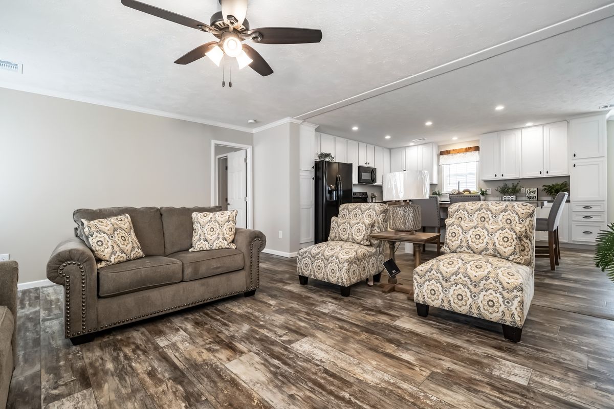 dd806c2d-d682-4054-a254-ccbe8ee49557 A living room with hardwood floors and a ceiling fan.