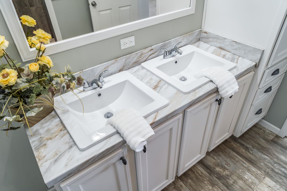 dfbbc25c-6373-41a1-b088-341746345544 A bathroom with two sinks and a mirror.