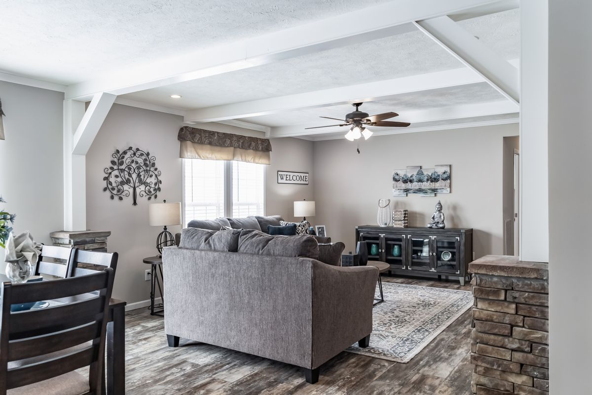 A living room with hardwood floors and a ceiling fan.