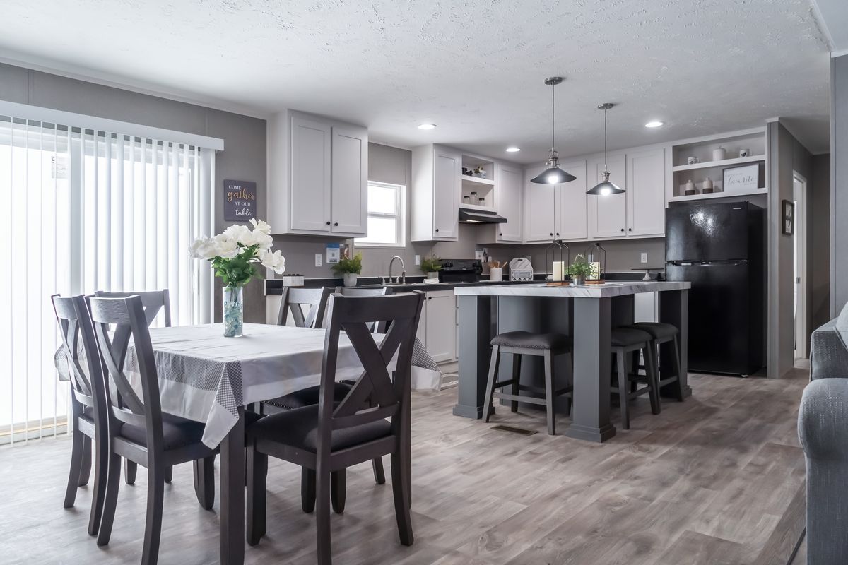 A kitchen and dining area in a mobile home.