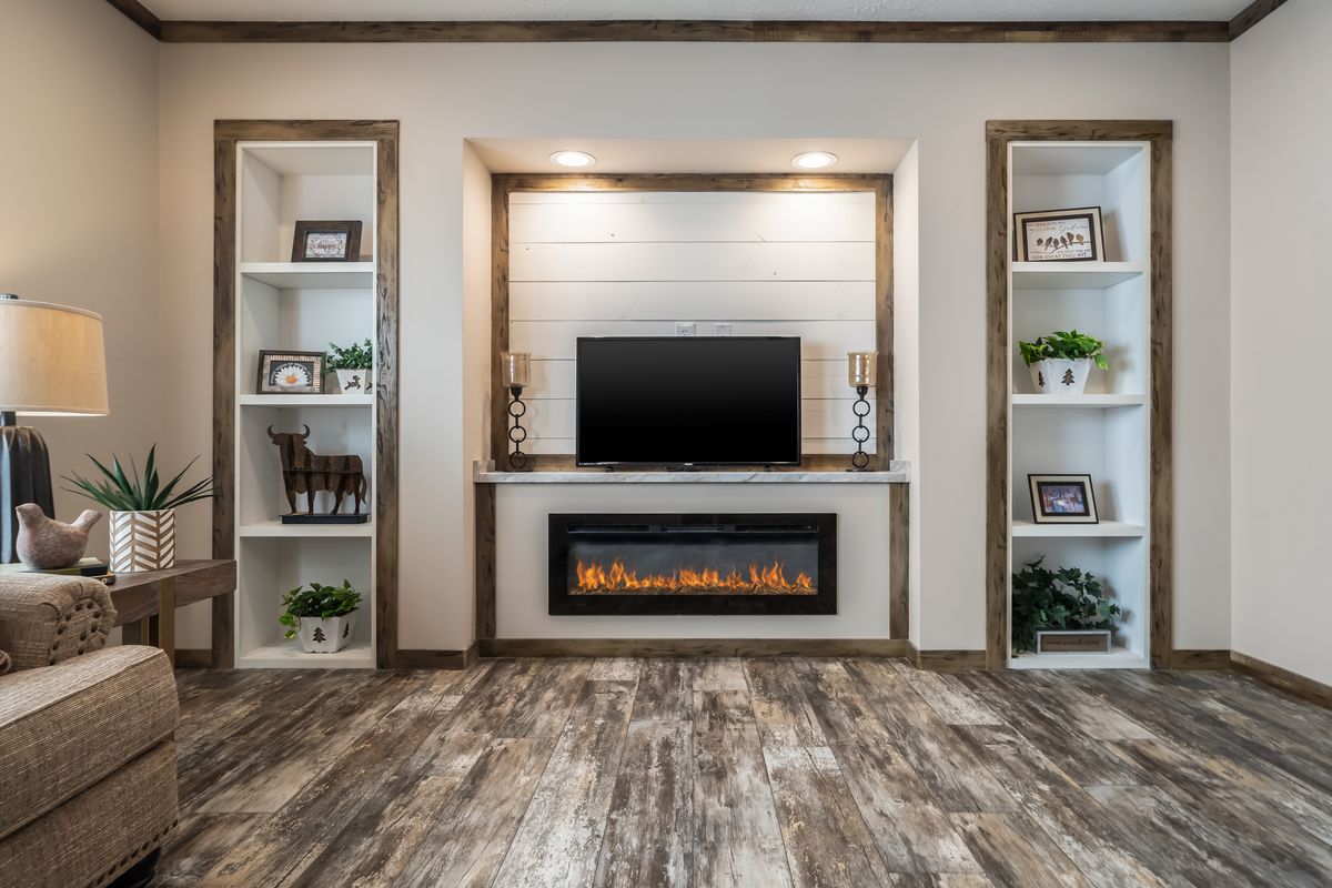 A living room with a fireplace and bookshelves.