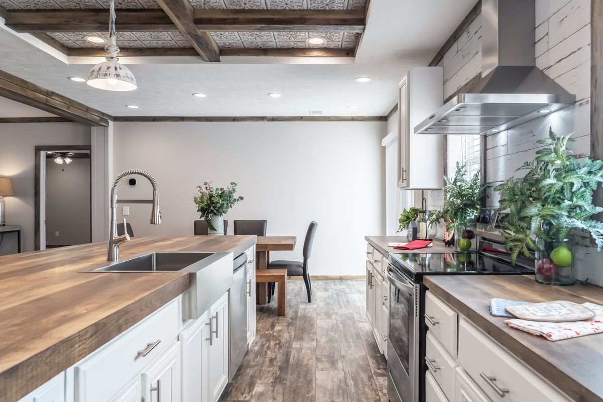 A kitchen with wood counter tops and wooden cabinets.