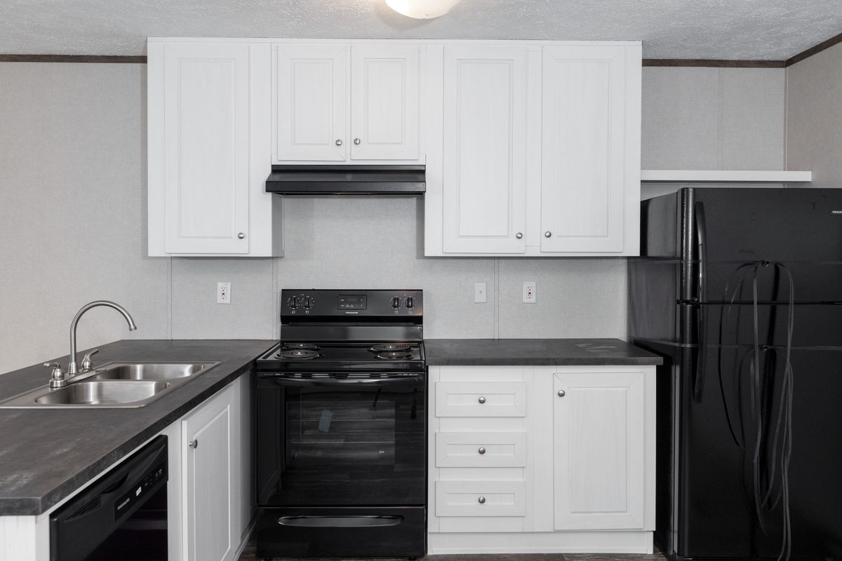 e765bfdb-4bce-4f64-a560-deccf5236eba A kitchen with black appliances and white cabinets.