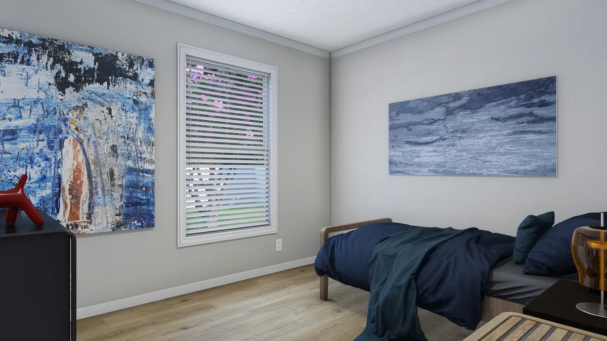 A bedroom with a blue bed and a painting on the wall.
