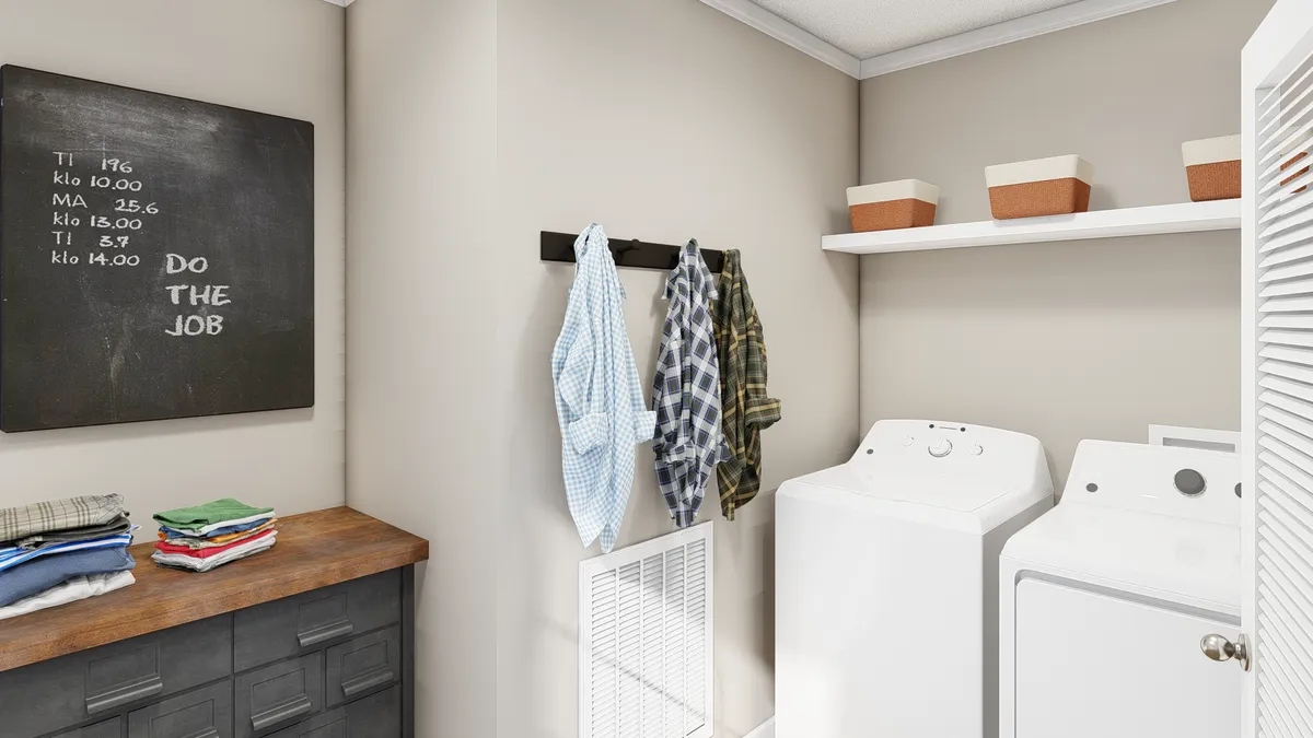 e85863c1-08b1-4100-a435-99fafe963d88 A laundry room with a washer and dryer.