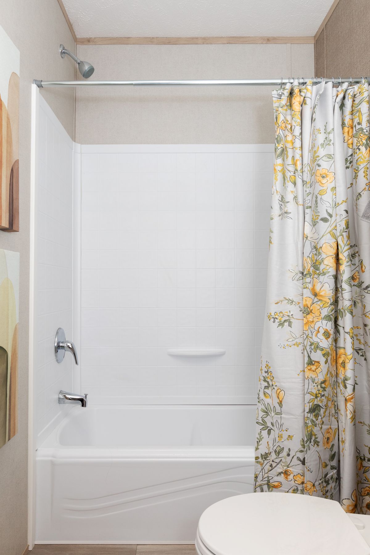 eb752610-479a-4cec-8188-71e2b5776a29 A bathroom with a toilet, shower, and shower curtain.