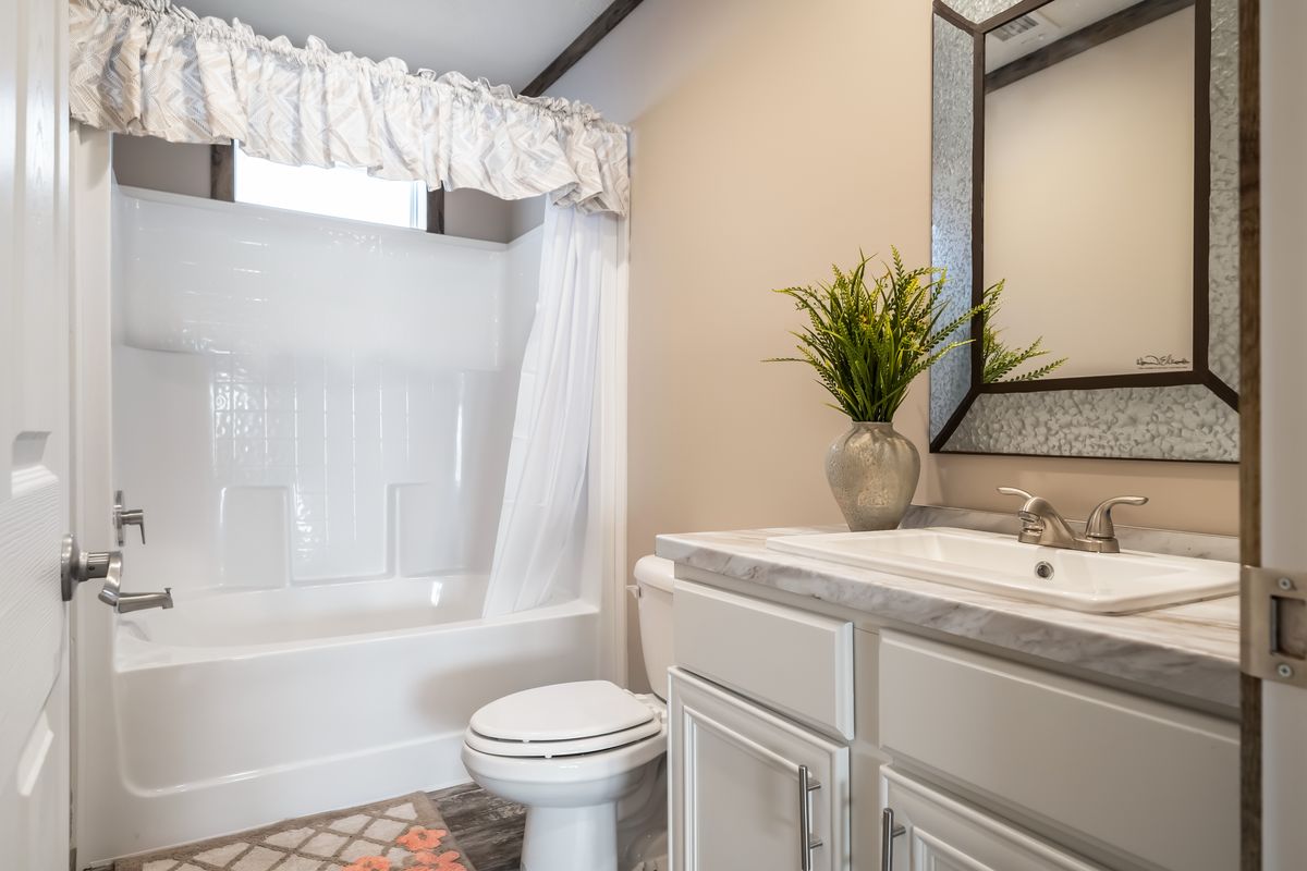 A white bathroom with a toilet and sink.
