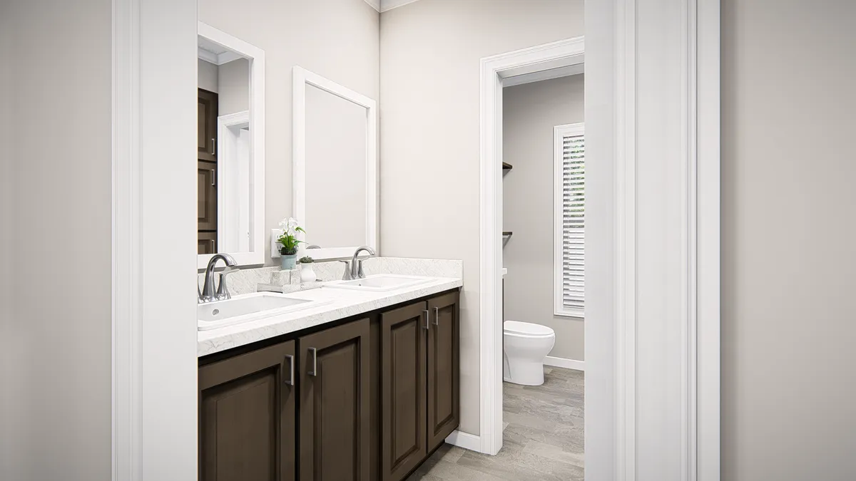 A bathroom with two sinks and a toilet.