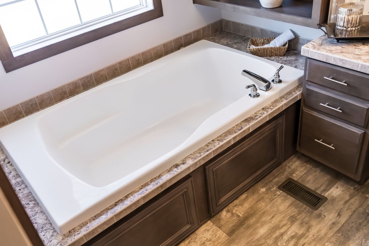 A bathroom with a bathtub and sink.